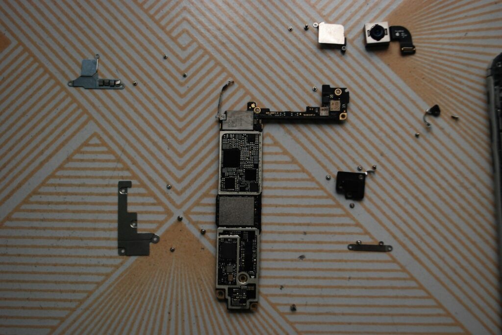 Close-up of a broken circuit board and electronics, representing e-waste recycling at Arizona PC Recycling