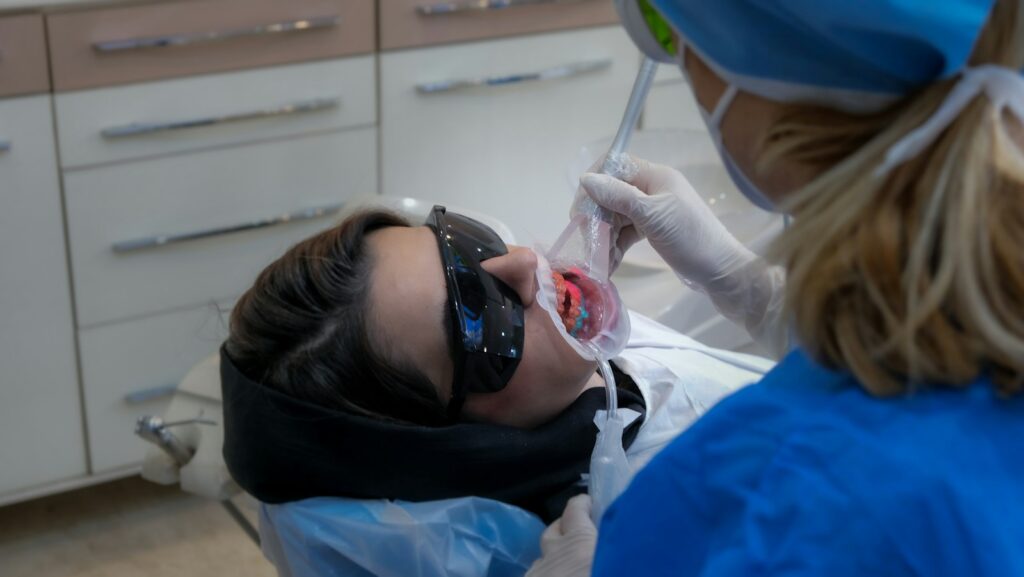 Dentist examining a patient in a dental clinic, representing dental practice technical SEO and website performance