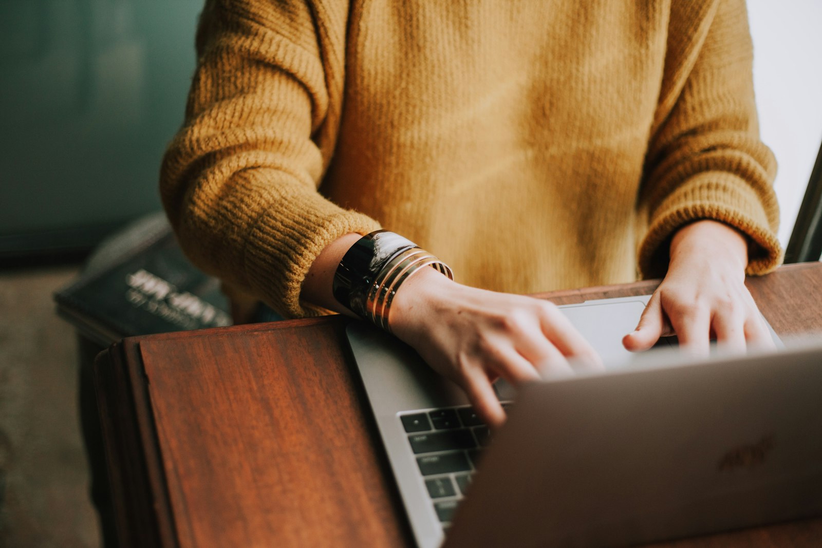 Person browsing a website on a laptop, representing e-commerce product page research and comparison